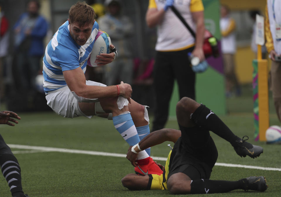 Matias Osadczuk of Argentina, left, is tackled by Omar Dixon of Jamaica during rugby seven match at the Pan Am Games in Lima, Peru, Friday, July 26, 2019. Argentina won the match 52-0. (AP Photo/Juan Karita)