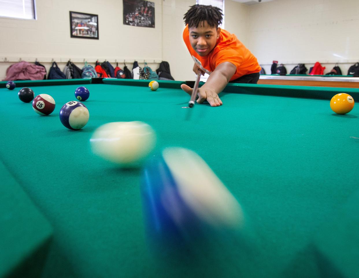 Kevon Sankey, 14, shoots pool after school at the Massillon Boys and Girls Club.
