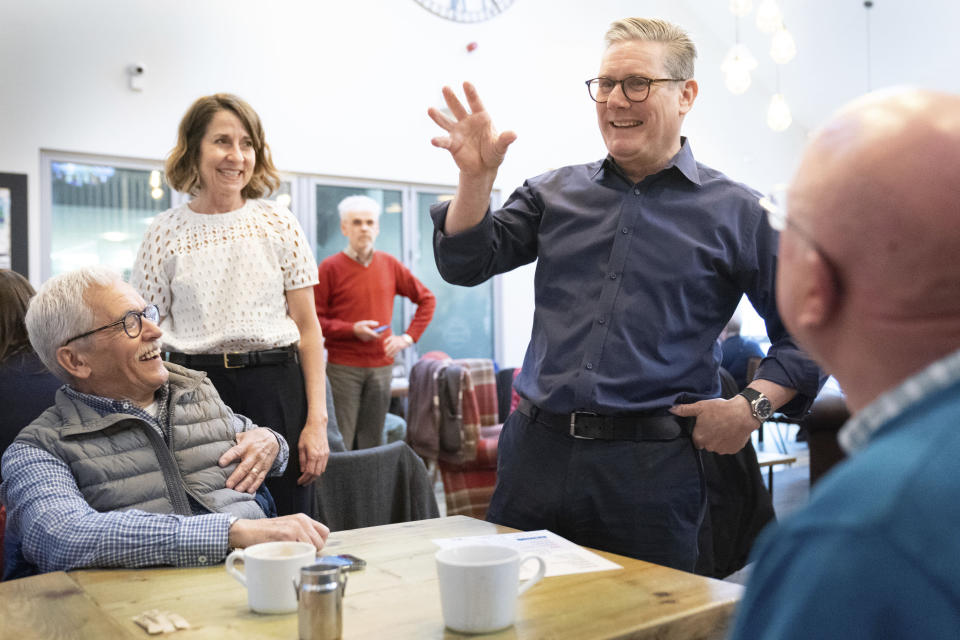 Labour Party leader Sir Keir Starmer, center right, and shadow work and pensions secretary Liz Kendall, centre left, meet pensioners to talk about the impact of the energy crisis and cost of living during a visit to the Bridge Cafe in Bolton, Greater Manchester, Britain, while on the General Election campaign trail, Tuesday June 4, 2024. (Stefan Rousseau/PA via AP)