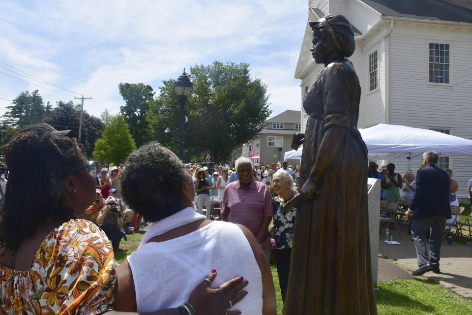 A monument of civil rights pioneer Elizabeth Freeman is unveiled in front of Sheffield's Old Parish Church in Sheffield, Mass., Sunday, Aug. 21, 2022. (Gillian Jones/The Berkshire Eagle via AP)