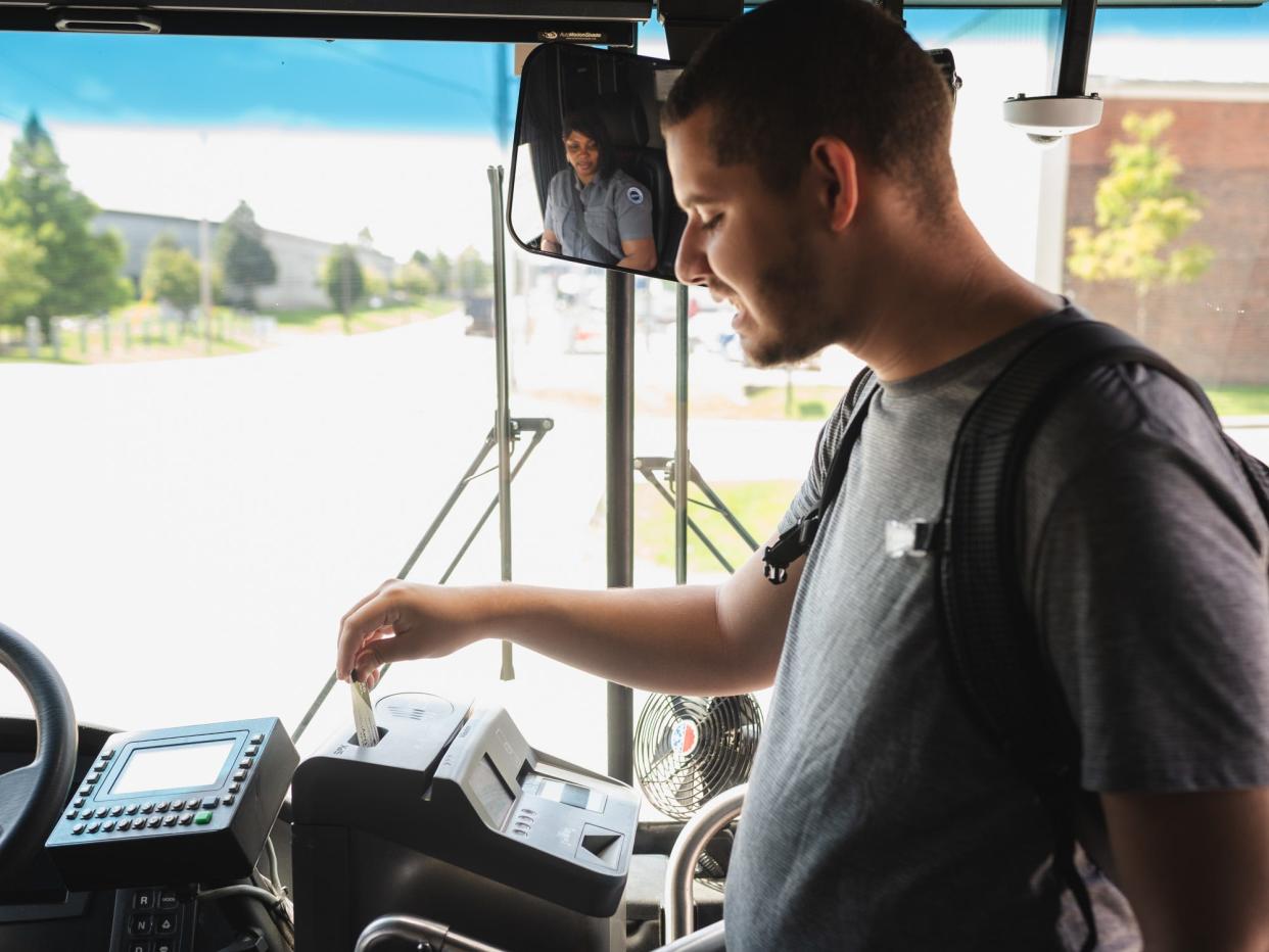 Johannes Rojahn, 21, who has been a student at Bridgeman Academy and Therapy, boarding a COTA bus after using the new phone app.
(Credit: COTA)