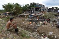 A man takes a break from cleaning his house following the flood brought by Typhoon Vamco, in Marikina, Metro Manila, Philippines, November 16, 2020. REUTERS/Lisa Marie David