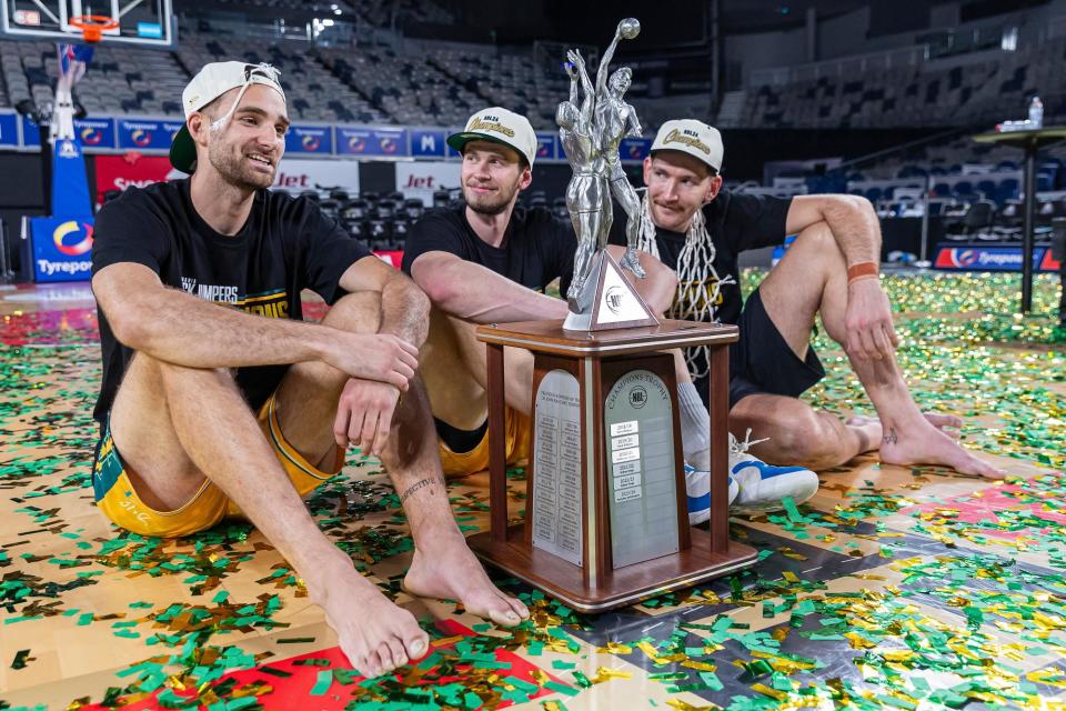 <span>Jack McVeigh, Clint Steindl and Will Magnay of the JackJumpers celebrate with the NBL championship trophy after defeating Melbourne United.</span><span>Photograph: Daniel Pockett/Getty Images</span>