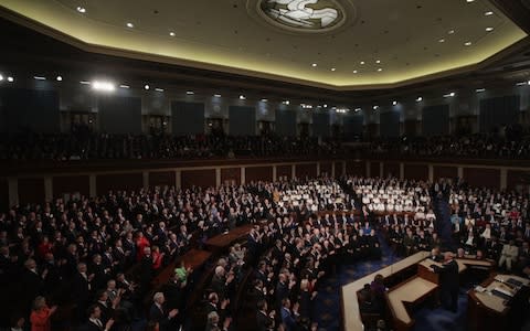 Democratic women in white contrast with the dark suited men in the chamber - Credit: &nbsp;Alex Wong/Getty&nbsp;