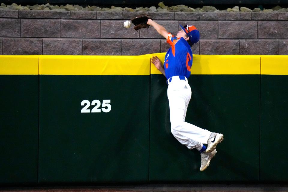 The ball pops out of the glove of New Albany, Ohio's Eddie Bloch for a two-run home run by El Segundo, Calif.'s Brody Brooks during the third inning of a baseball game at the Little League World Series in South Williamsport, Pa., Thursday, Aug. 17, 2023.