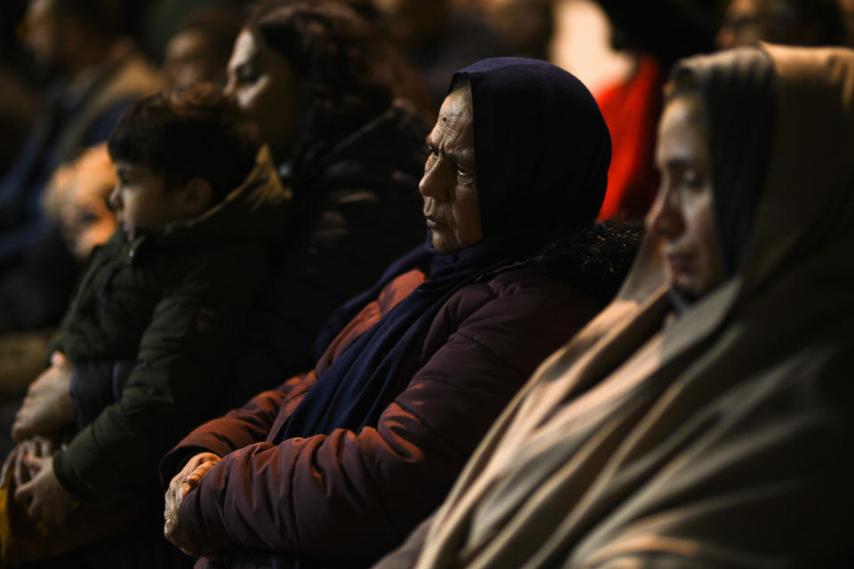 Family members of the victims attend "La renaissance des filles afghanes" (The rebirth of Afghan girls) in Crotone, southern Italy, Saturday, Feb. 24, 2024. The show, curated by the Afghan community in Italy, is part of the celebrations to help mark the first anniversary of the shipwreck of a migrant boat that capsized in the early morning of Sunday, Feb. 26, 2023, at a short distance from the shore in Steccato di Cutro, near Crotone killing at least 94 people. Survivors and family members of the victims are converging in the area for a commemoration on Monday, Feb. 26, 2024, on the first anniversary of the disaster. (AP Photo/Valeria Ferraro)