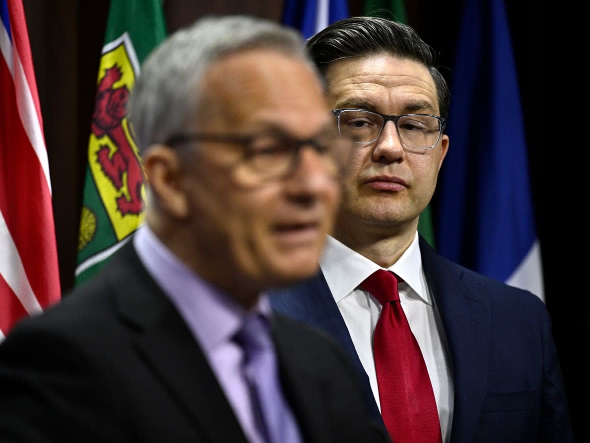 Conservative Leader Pierre Poilievre listens as Conservative MP Ed Fast speaks during a news conference on his private member's bill on medical assistance in dying, on Parliament Hill in Ottawa, Monday, March 6, 2023. (Justin Tang/Canadian Press - image credit)