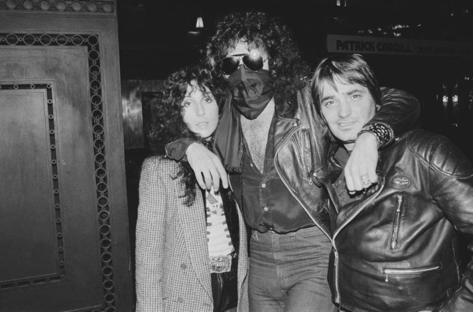 London, 1978: A masked Gene Simmons embraces Cher and an unknown friend (Getty Images)