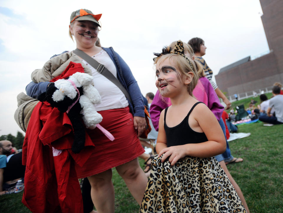 Molly Haen, 3 arrived in costume with her mother Rachel Haen of St. Louis Park, Minn. for the Walker Art Center's first "Internet Cat Video Film Festival," showcasing the best of cat films on the Internet in Minneapolis Thursday Aug. 30, 2012. The Walker Art Center in Minneapolis held its first-ever online cat video festival, a compilation of silly cat clips that have become an Internet phenomenon, attracting millions of viewers for some of the videos. (AP Photo/Craig Lassig)