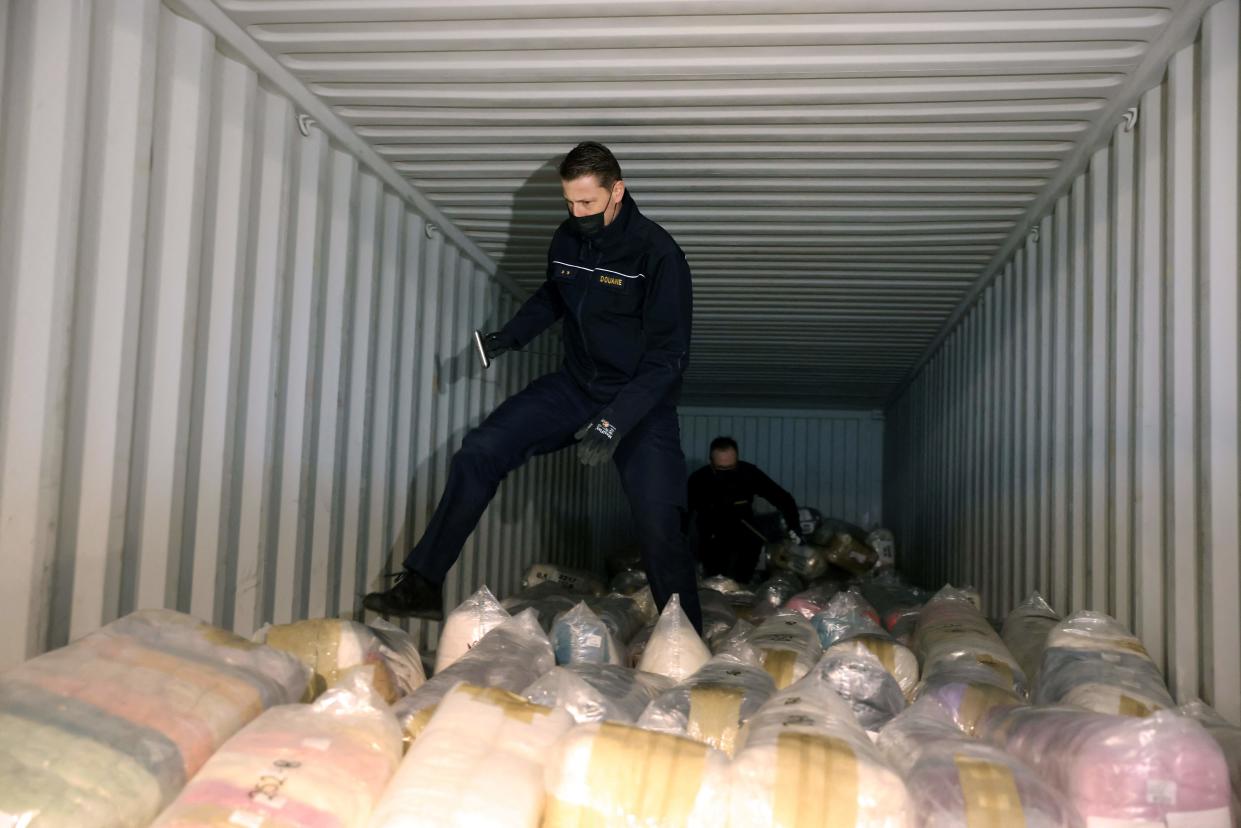 Belgian customs officers search for drugs in a container at the port of Antwerp
