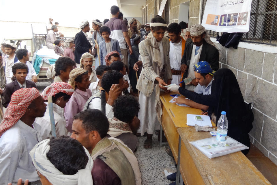 Beneficiary heads of households receive their food vouchers distributed monthly in Haymah Dakhliyah, Sanaa Governorate.&nbsp;