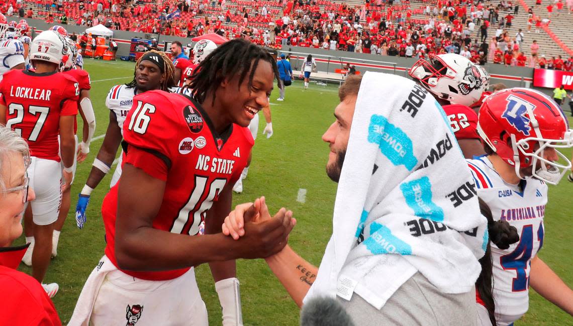 N.C. State quarterback Grayson McCall (2) greets quarterback CJ Bailey (16) after the Wolfpack’s 30-20 victory over LA Tech at Carter-Finley Stadium in Raleigh, N.C., Saturday, Sept. 14, 2024.