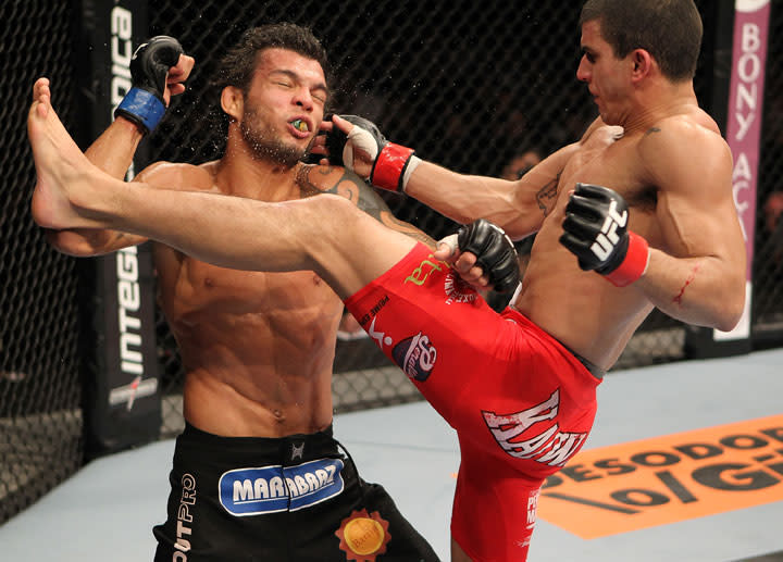 BELO HORIZONTE, BRAZIL - JUNE 23: (R-L) Felipe Arantes lands a flying knee against Milton Vieira during their UFC 147 featherweight bout at Estadio Jornalista Felipe Drummond on June 23, 2012 in Belo Horizonte, Brazil.