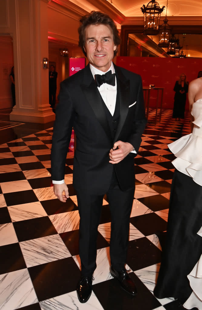 Celebrity in a classic black tuxedo with a bow tie at a formal event