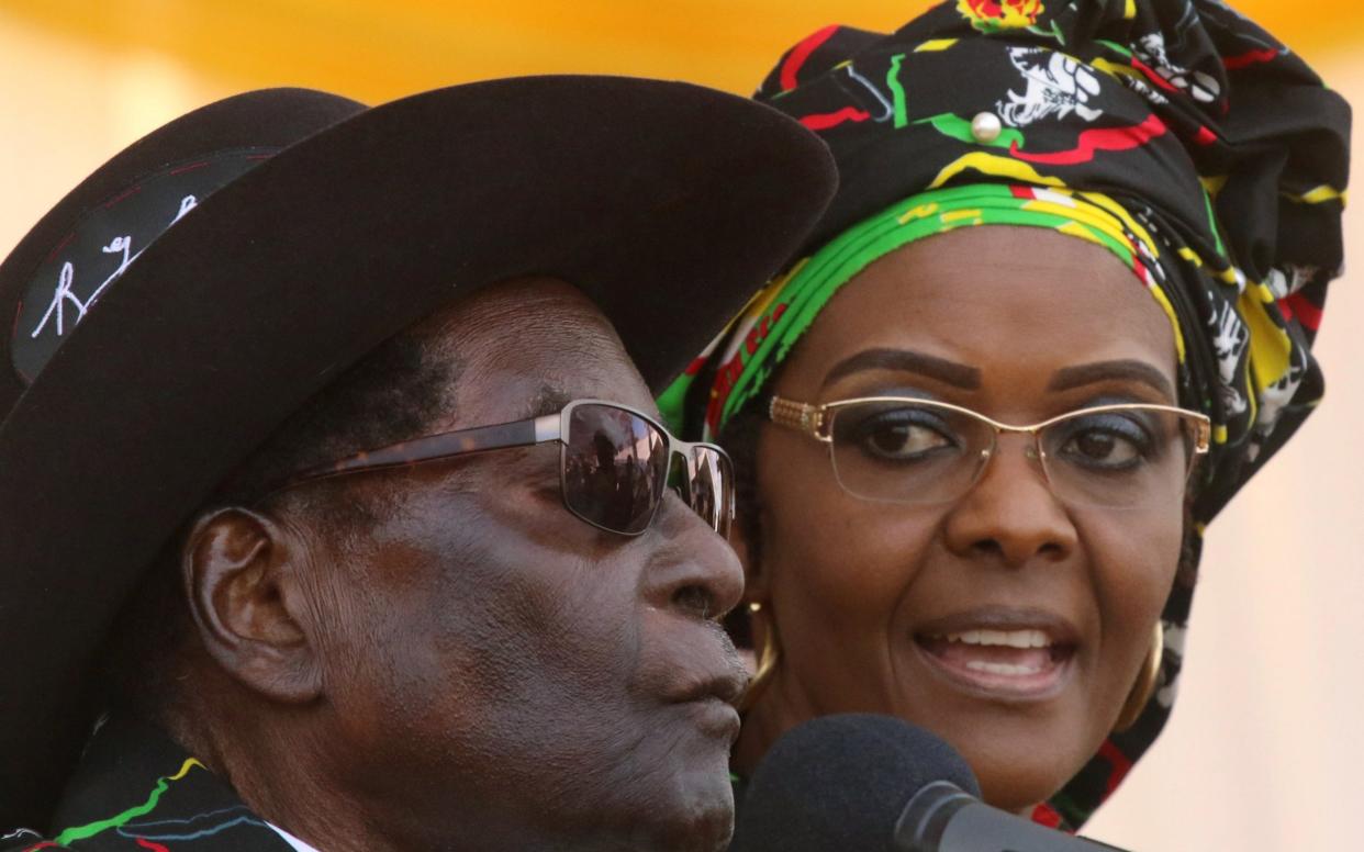 President Robert Mugabe and his wife Grace attend a rally  - REUTERS