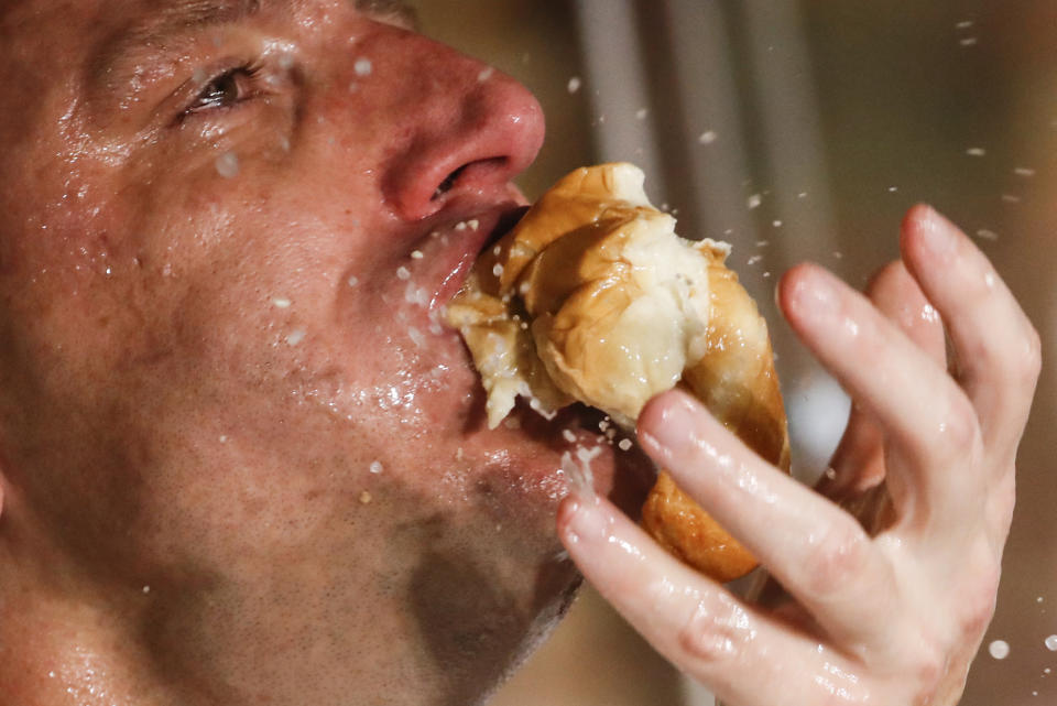 Competitive eater Joey Chestnut sets a new world record with 75 hot dogs to win the men's division of the Nathan's Famous July Fourth hot dog eating contest, Saturday, July 4, 2020, in the Brooklyn borough of New York. (AP Photo/John Minchillo)