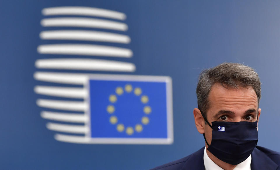 Greek Prime Minister Kyriakos Mitsotakis arrives for an EU summit at the European Council building in Brussels, Sunday, July 19, 2020. Leaders from 27 European Union nations meet face-to-face for a third day to assess an overall budget and recovery package spread over seven years estimated at some 1.75 trillion to 1.85 trillion euros. (John Thys, Pool Photo via AP)