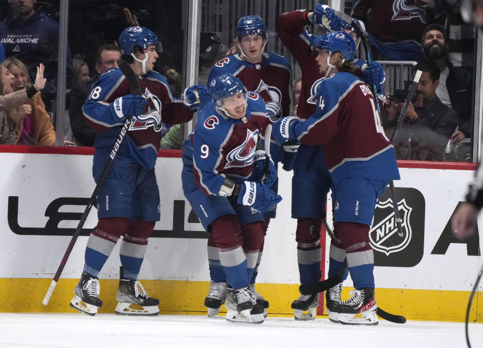 Colorado Avalanche center Evan Rodrigues, front center, celebrates his goal against the Seattle Kraken with defensemen Cale Makar, Josh Manson and Bowen Byram, from left, during the second period of an NHL hockey game Friday, Oct. 21, 2022, in Denver. (AP Photo/David Zalubowski)