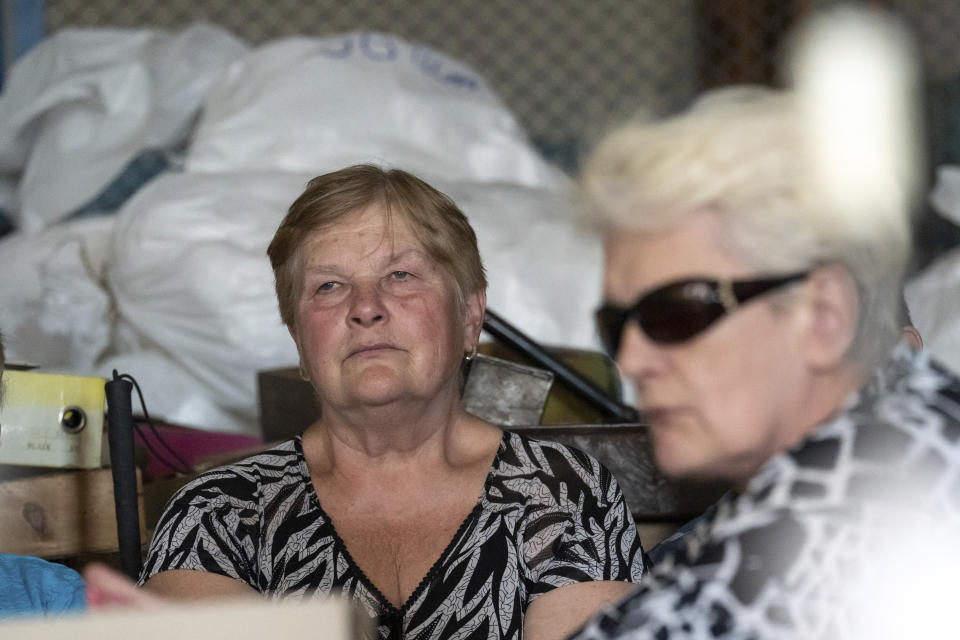 Women sit in a workshop in a manufacturing plant where visually impaired people used to work until it was shuttered following a Russian air assault in Kyiv, Ukraine, on May 30, 2023. Losing the place of work is just one of a multitude of challenges that people with visual impairments face across Ukraine since Russia launched a full-scale invasion in February 2022. (AP Photo/Roman Hrytsyna)