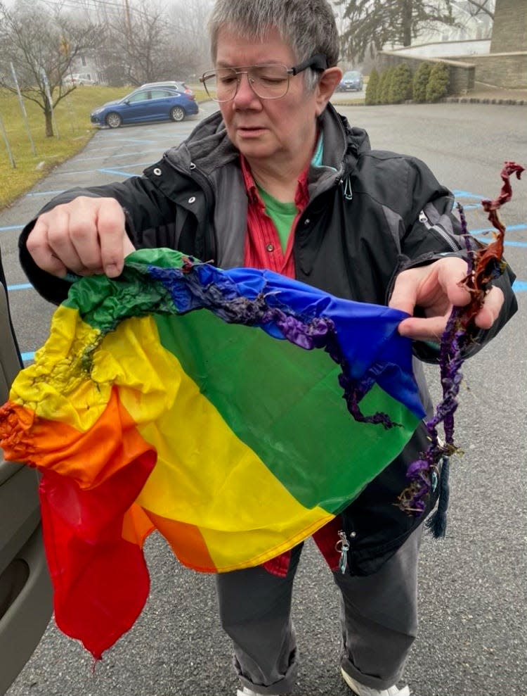 Sue Harris, now the president of the newly formed PFLAG Sussex County chapter, holds a Pride flag that flew outside the Sparta United Methodist Church and was discovered burned prior to church services Sunday, Jan. 2, 2022.