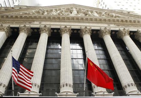 FILE PHOTO: The flags of the United States and China hang outside of the New York Stock Exchange March 30, 2011. REUTERS/Lucas Jackson