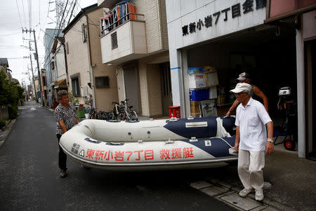 FILE PHOTO: Residents of Tokyo's Katsushika ward show a floating boat which they keep for a possible flood in Tokyo, Japan August 24, 2018. REUTERS/Kim Kyung-Hoon/File Photo