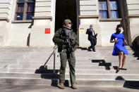 A Georgia State Patrol S.W.A.T. team member stands guard outside the Georgia State Capitol building Thursday, Jan. 14, 2021, in Atlanta. With the FBI warning of potential violence at all state capitols Sunday, Jan. 17, the ornate halls of government and symbols of democracy looked more like heavily guarded U.S. embassies in war-torn countries. (AP Photo/John Bazemore)