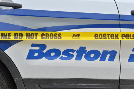 A Boston Police cruiser is marked with crime scene tape outside the scene after a burning propane tank was left near an unoccupied police cruiser in Boston, Massachusetts, U.S., January 20, 2017. REUTERS/Josh Reynolds