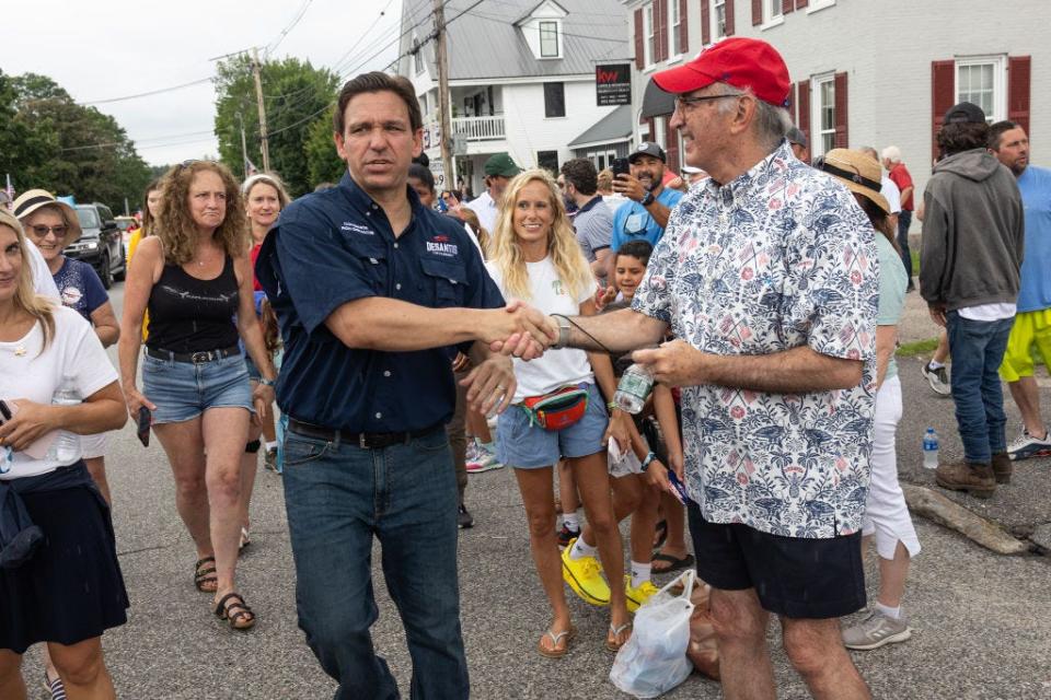 DeSantis shaking hands with a resident.