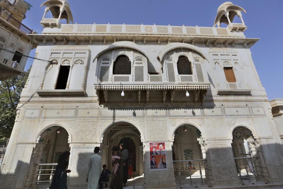 People from Pakistani Hindu community visit at the Sadhu Bela temple, located in an island on the Indus River, in Sukkur, Pakistan, Wednesday, Oct. 26, 2022. On the banks of the Indus River, which flows through Pakistan and into its southern Sindh province, Hindus wait for brightly colored boats to ferry them to an island that has housed Sadhu Bela temple for almost 200 years. The island was gifted to the Hindu community by wealthy Muslim landlords in Sindh, an unthinkable act in modern-day Pakistan. (AP Photo/Fareed Khan)