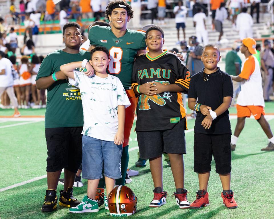 Florida A&M quarterback Jeremy Moussa (8) takes a photo with some little Rattlers after defeating the West Florida Argonauts at Ken Riley Field at Bragg Memorial Stadium in Tallahassee, Florida on Saturday, Sept. 16, 2023.