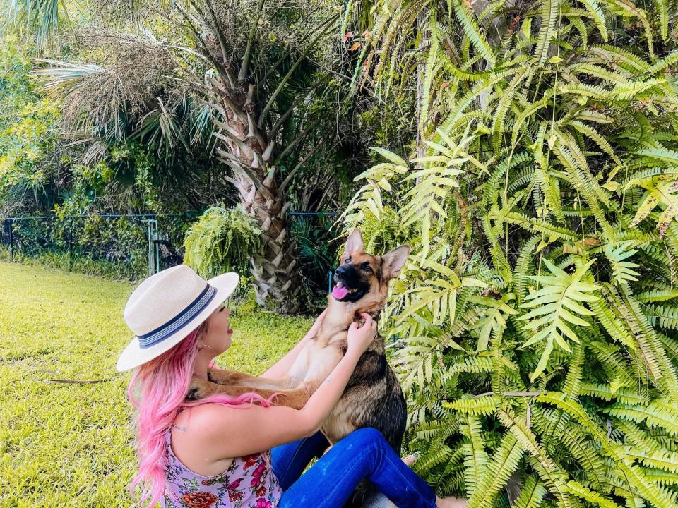 Liz Scott of Naples embraces her dog Harley after being reunited Tuesday. The German Shepherd went missing during hurricane clean-up last week but showed up again three days later at her back door.