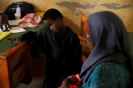 Deko Ibrahim Abdille (R) and her daughter Fatuma visit a health clinic at the Kakuma refugee camp in northern Kenya, March 5, 2018. REUTERS/Baz Ratner