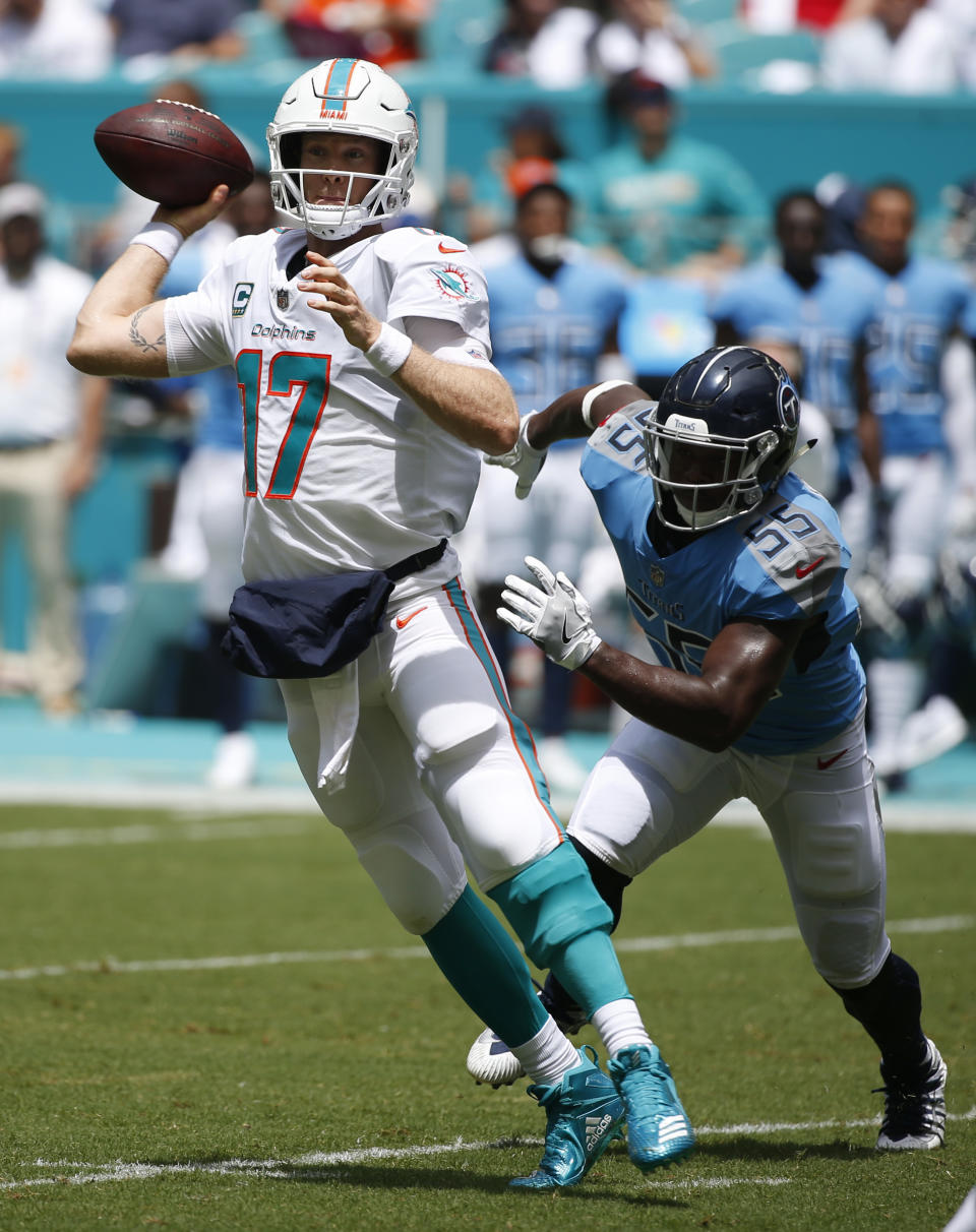Miami Dolphins quarterback Ryan Tannehill (17) looks to pass as he pursued by Tennessee Titans linebacker Jayon Brown (55), during the first half of an NFL football game, Sunday, Sept. 9, 2018, in Miami Gardens, Fla. (AP Photo/Wilfredo Lee)