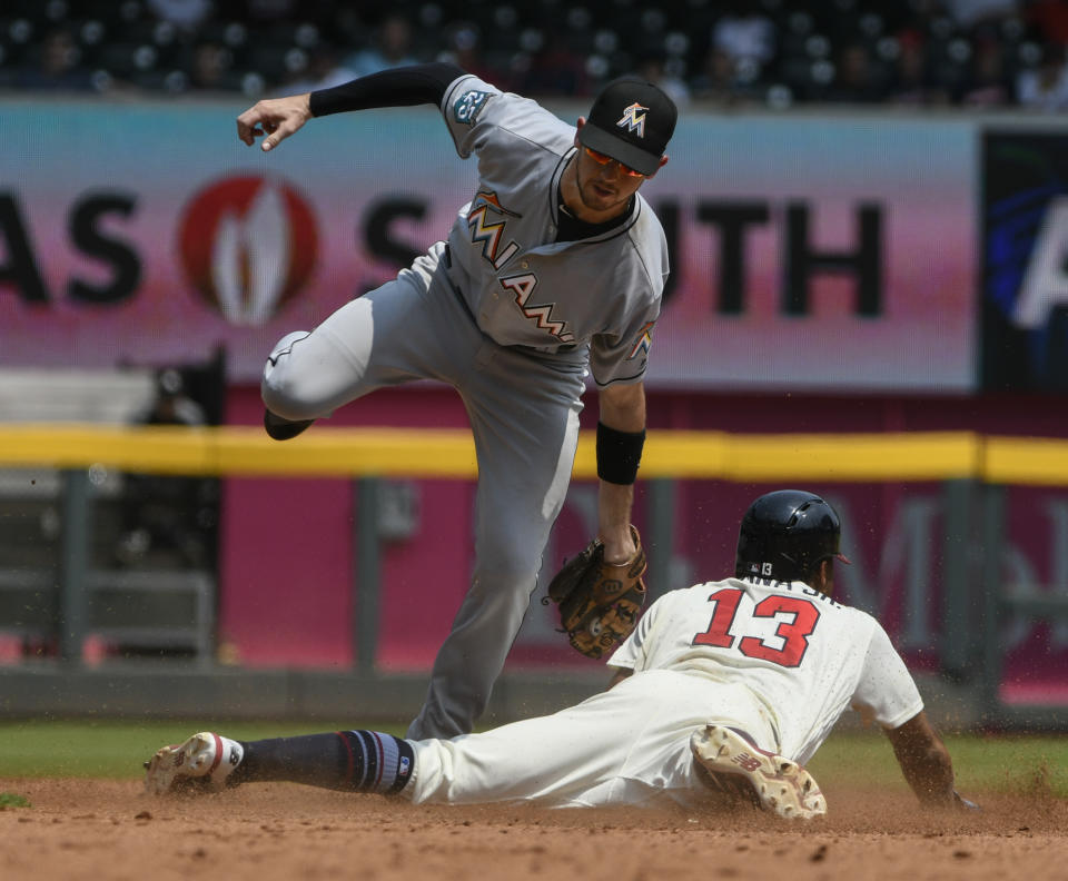 Atlanta Braves' Ronald Acuna Jr. (13) steals second base as Miami Marlins shortstop JT Riddle comes down from a high throw and late tag during the fifth inning of the first game in a baseball doubleheader Monday, Aug. 13, 2018, in Atlanta. (AP Photo/John Amis)