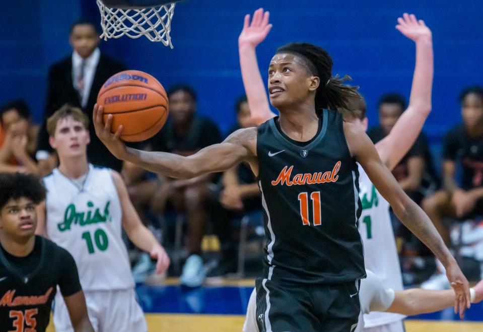 Manual's Dietrich Richardson makes a move to the basket past Peoria Notre Dame in the second half of their boys basketball game Friday, Dec. 2, 2023 at PND High School. The Rams defeated the Irish 46-43.