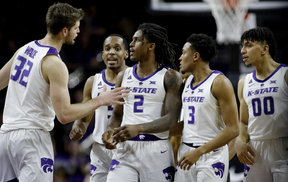 Teammates gather around Kansas State's Cartier Diarra (2) after he drew a foul during the second half of an NCAA college basketball game against Texas Tech Tuesday, Jan. 22, 2019, in Manhattan, Kan. Kansas State won 58-45. (AP Photo/Charlie Riedel)