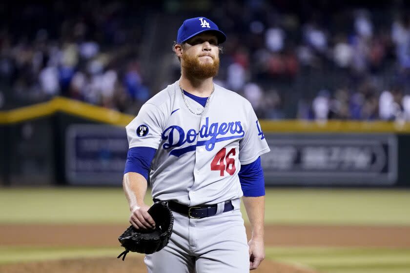 Los Angeles Dodgers relief pitcher Craig Kimbrel walks off the field after giving up a game-ending, three-run home run to Arizona Diamondbacks' Sergio Alcantara during the 10th inning of a baseball game in Phoenix, Wednesday, Sept. 14, 2022. The Diamondbacks won 5-3. (AP Photo/Ross D. Franklin)