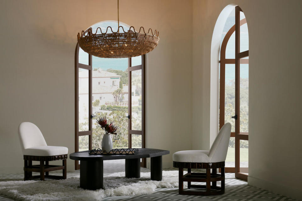 The Mar chandelier, Tribal coffee table and Vargueño chairs by Laura Kirar for Arteriors