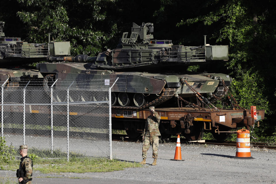 Military police walk near Abrams tanks on a flat car in a rail yard ahead of a Fourth of July celebration that President Donald Trump says will include military hardware in Washington on Monday, July 1, 2019. | Patrick Semansky—AP