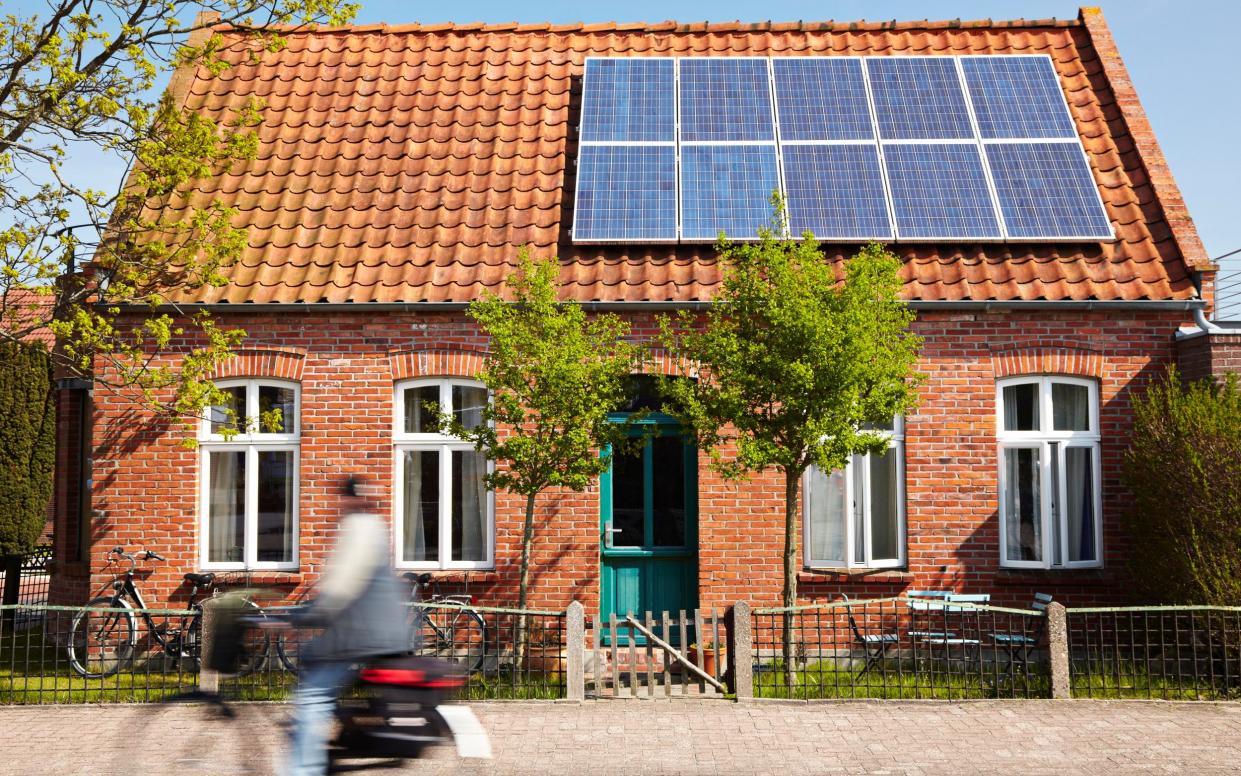 house with solar panels - Getty