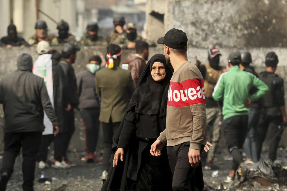 Anti-government protesters gather during clashes with security forces on Rasheed Street in Baghdad, Iraq, Friday, Dec. 6, 2019. (AP Photo/Hadi Mizban)