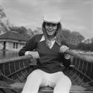 <p>Raquel Welch looks the part of a British boater with a collared shirt under a sweater, white trousers, and an ivy cap for an outing at the Serpentine in London. </p>