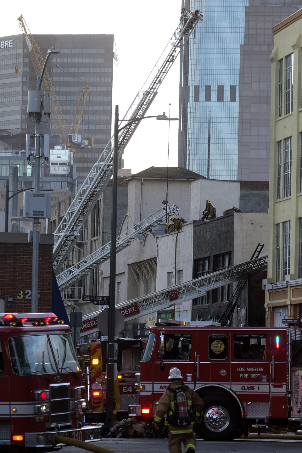 Los Angeles Fire Department firefighters work the scene of a structure fire that injured multiple firefighters, according to a fire department spokesman, Saturday, May 16, 2020, in Los Angeles. (AP Photo/Ringo H.W. Chiu)