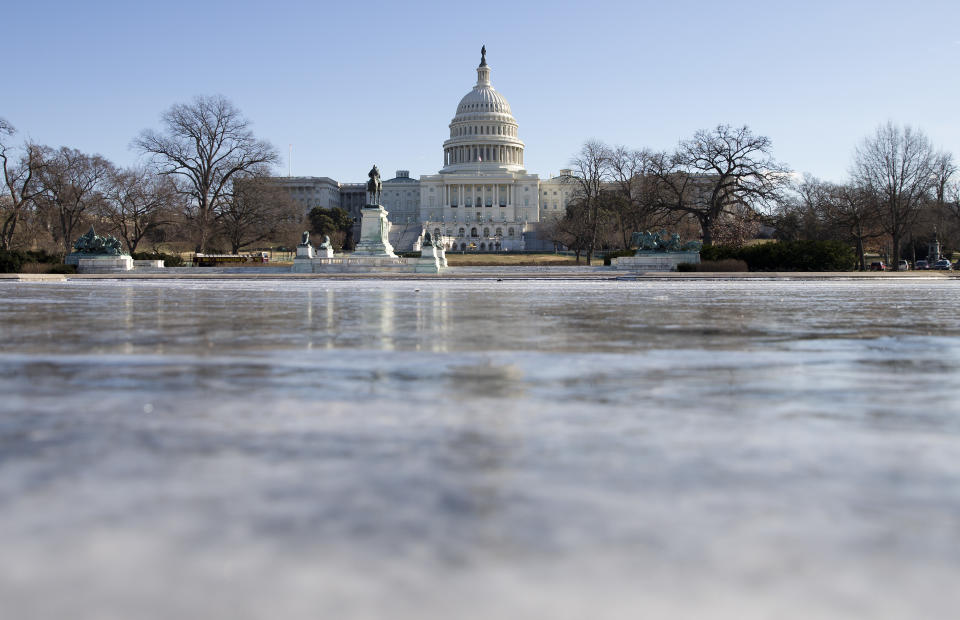 The reflecting pool in front of the U.S. Capitol building is frozen over, Tuesday, Jan. 7, 2014 in Washington. Frigid air that snapped decades-old records will make venturing outside dangerous for a second straight day Tuesday, this time spreading to southern and eastern parts of the U.S. and keeping many schools and businesses shuttered. Residents driven from their homes by power outages in the Midwest longed to return to their own beds. (AP Photo/ Evan Vucci)