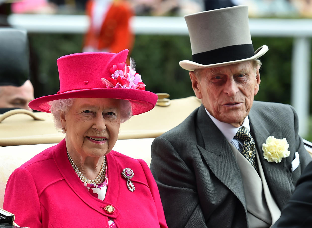 Britain's Queen Elizabeth II and Britain's Prince Philip, Duke of Edinburgh arrive by horse-drawn carriage on the first day of the annual Royal Ascot horse racing event near Windsor, Berkshire, on June 16, 2015. AFP PHOTO / BEN STANSALL (Photo by Ben STANSALL / AFP) (Photo by BEN STANSALL/AFP via Getty Images)