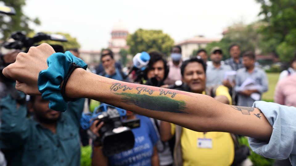 An activist displays a tattoo reading "Born this way" in the courtyard of India's Supreme Court in New Delhi on October 17, 2023.  - Sajjad Hussain/AFP/Getty Images