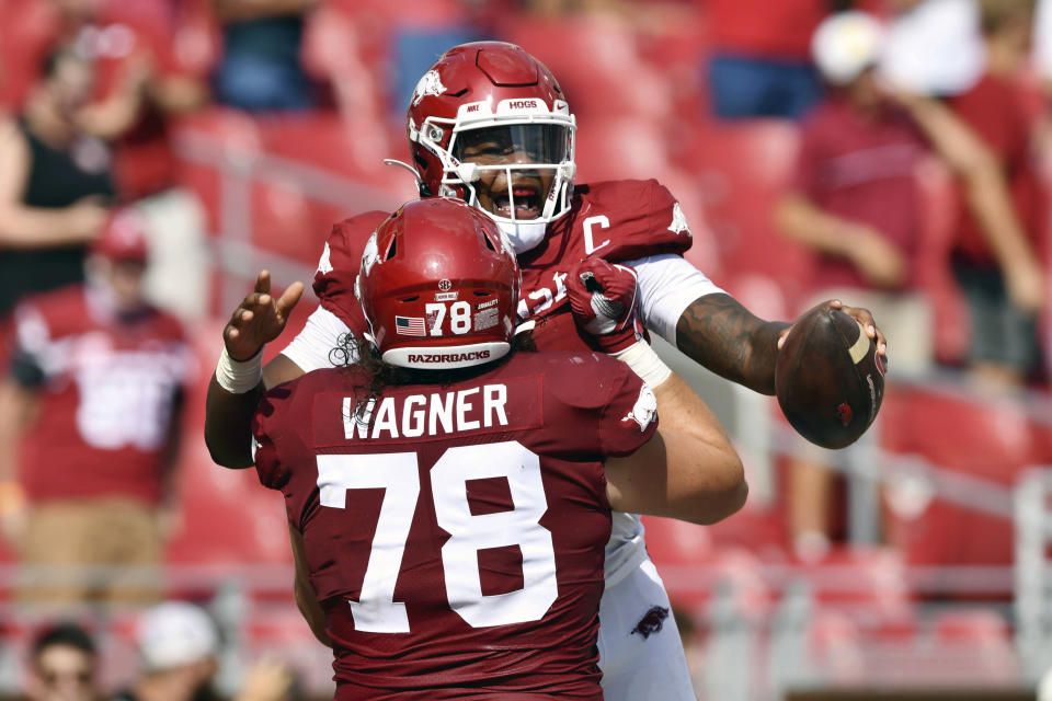 Arkansas quarterback KJ Jefferson (1) celebrates with teammate Dalton Wagner (78) during the first half of an NCAA college football game against Rice, Saturday, Sept. 4, 2021, in Fayetteville, Ark. (AP Photo/Michael Woods)