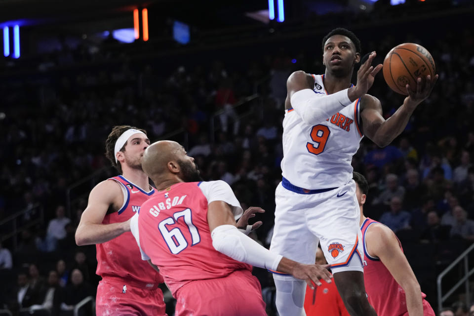 New York Knicks guard RJ Barrett (9) goes to the basket past Washington Wizards forward Taj Gibson (67) during the first half of an NBA basketball game Wednesday, Jan. 18, 2023, at Madison Square Garden in New York. (AP Photo/Mary Altaffer)