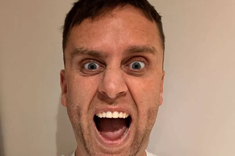 A man with a surprised expression on his face
